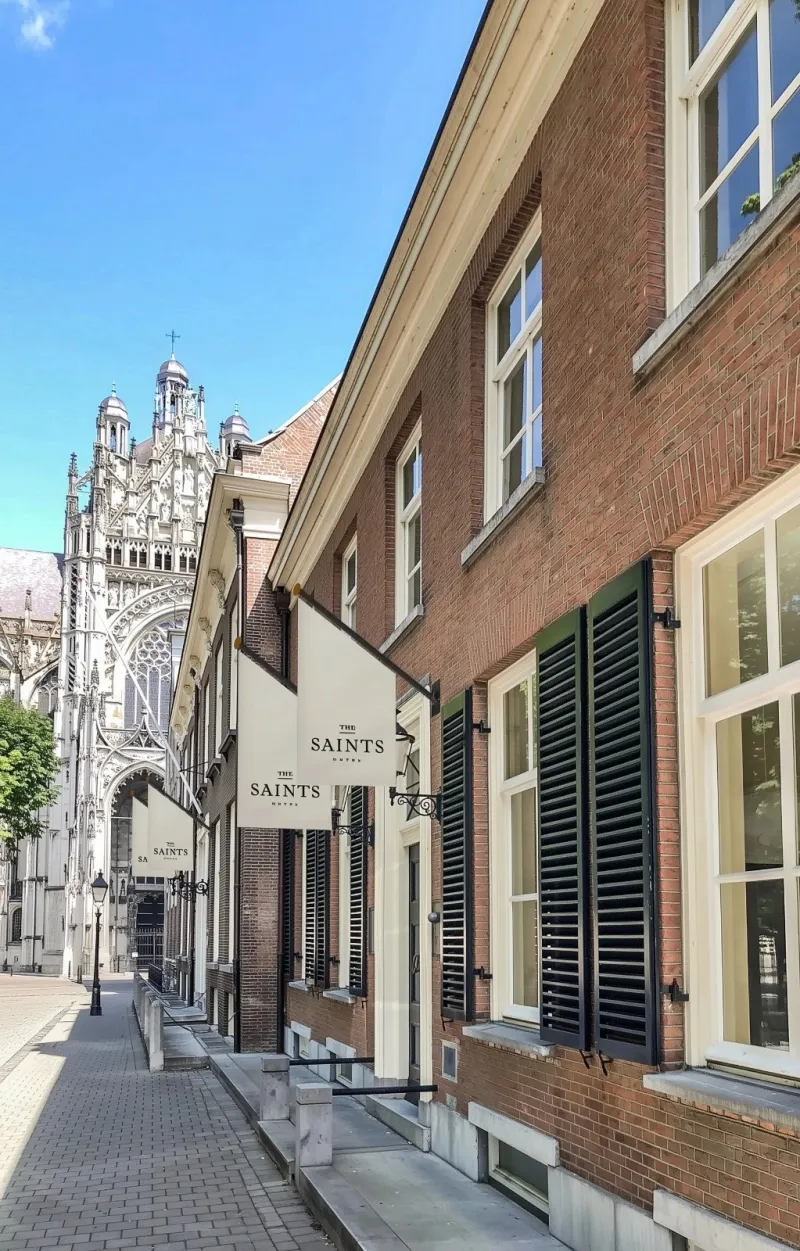 Street beside the hotel with The Saints sign and St John's Cathedral in the background